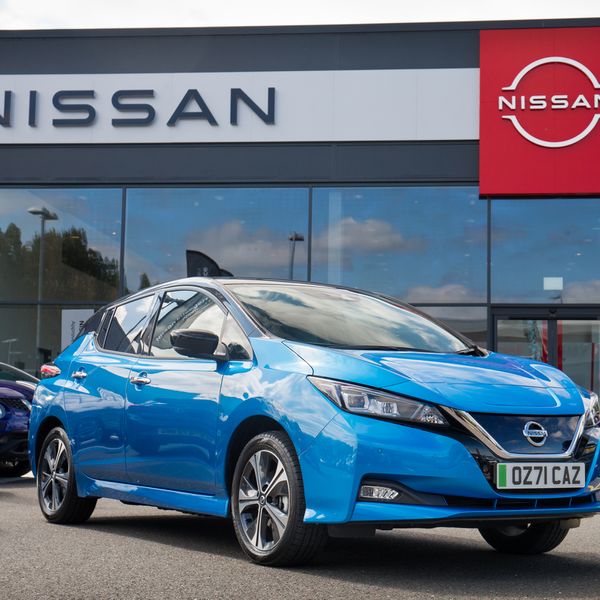 Nissan Leaf in front of dealer, blue, UK plates, 71 registration